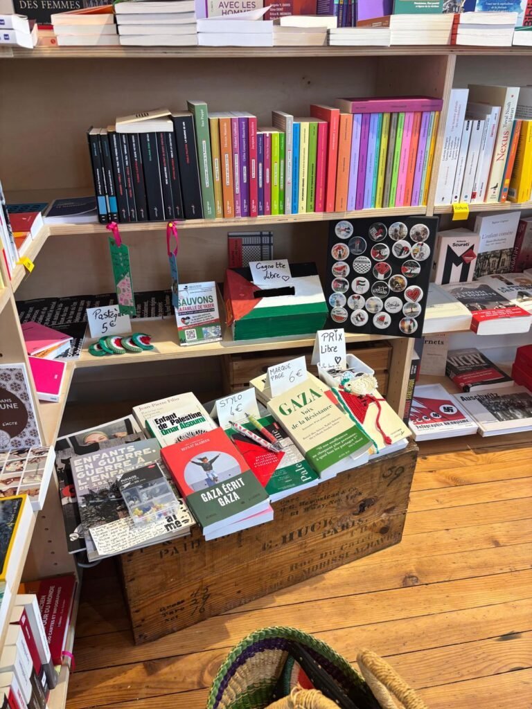 Boîte à dons et créations solidaires accueillies dans une librairie.
